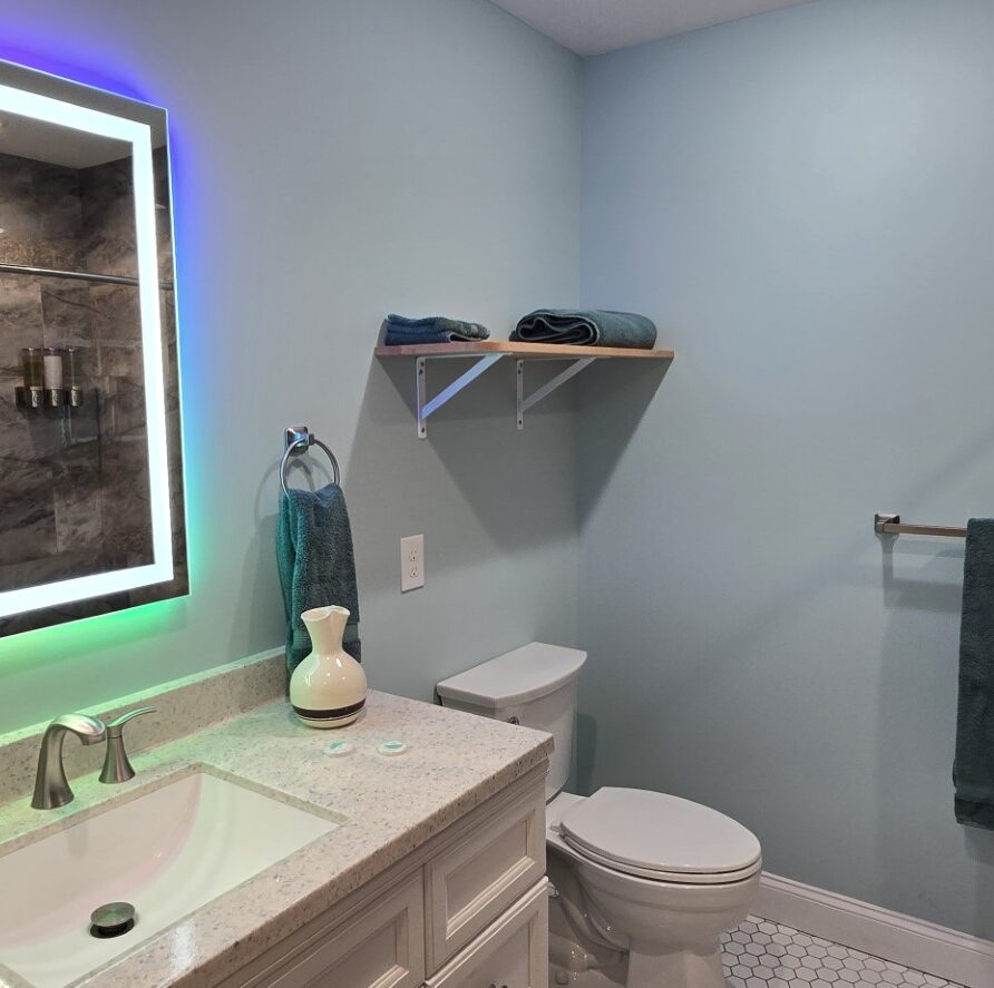 View of multicolored backlit mirror in private bathroom of Suite 3 at the London Guest House