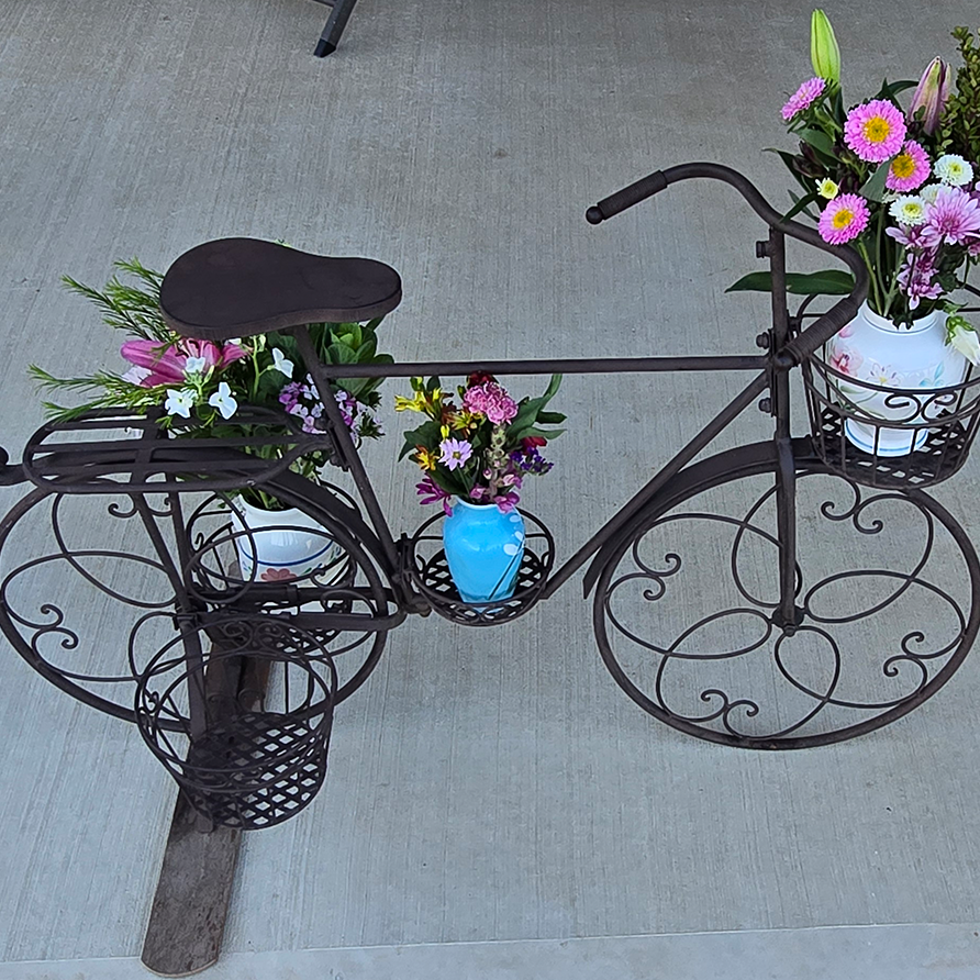 Bike-Flowers-892x892-1 - London Guest House Bicycle decor with flowers on the back porch at the London Guest House